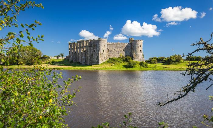 Image of Carew Castle at a different angle as well as the large pond.